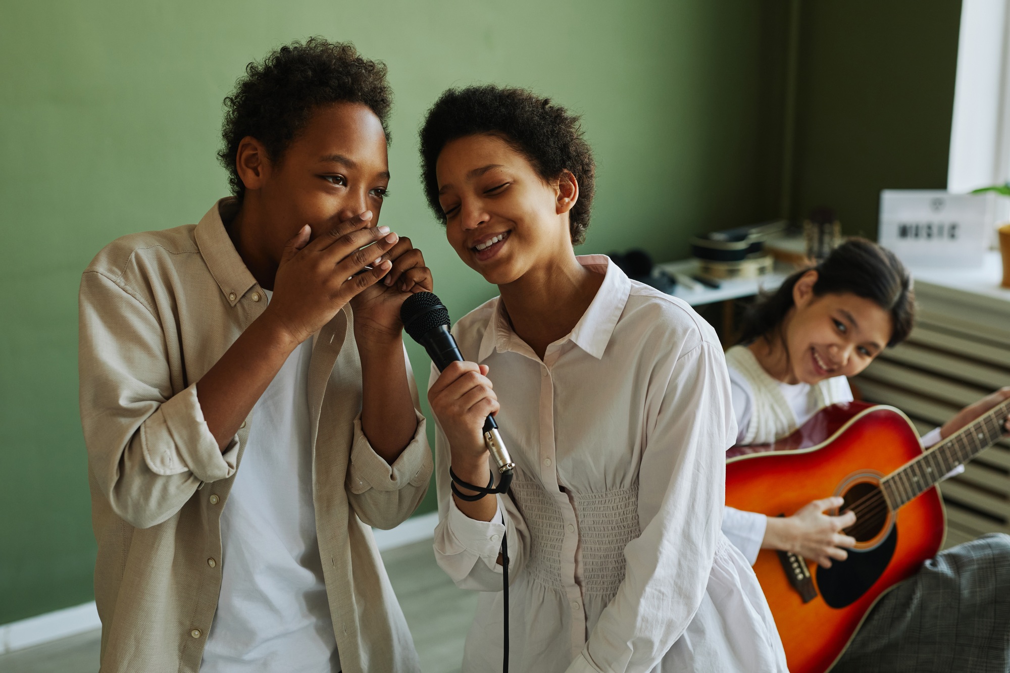 Youthful African American schoolchildren performing song during repetition